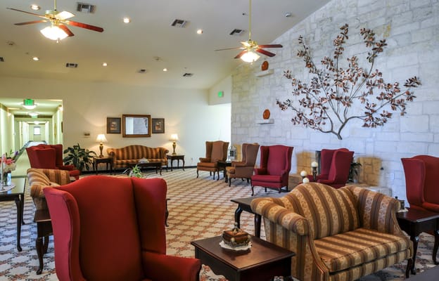 Cozy lobby seating area with armchairs and a decorative wall