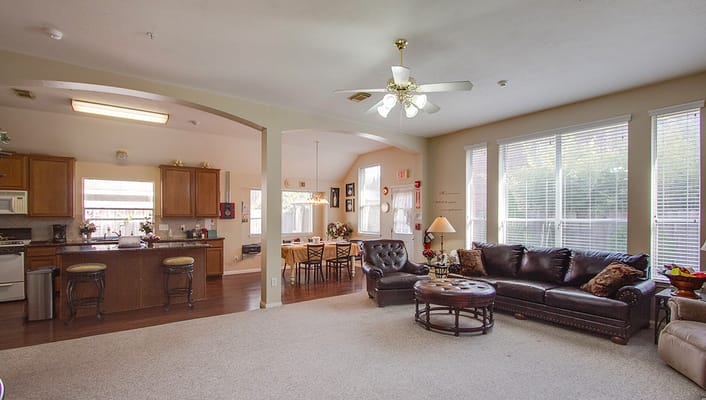 Spacious living room with a kitchen in the background