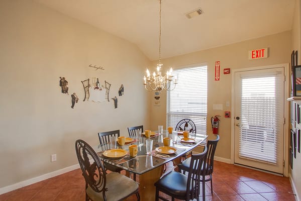 Dining table set with place settings in a bright dining room