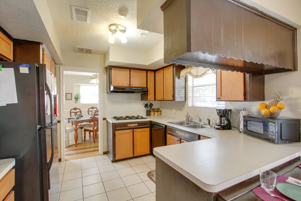 Spacious kitchen with appliances and dining area view