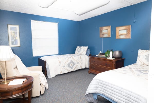 Interior of a shared resident room with two beds and furniture