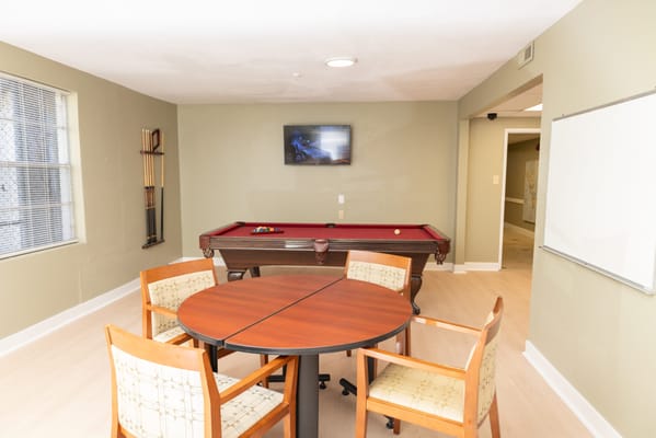 Activity room with a pool table and seating