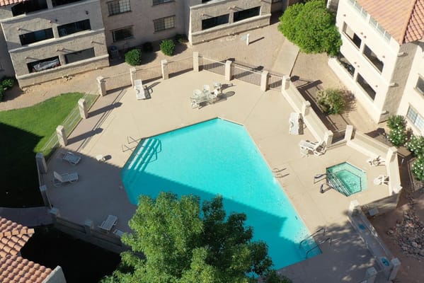 Aerial view of a serene pool area with lounge chairs