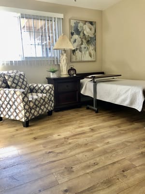 Cozy corner of a resident room with chair and bed