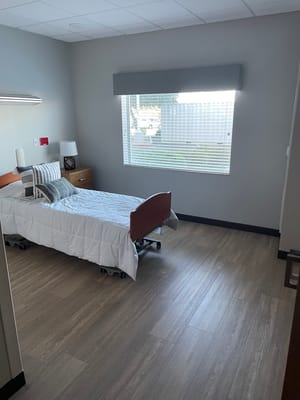 Bright, empty resident room with a bed and window