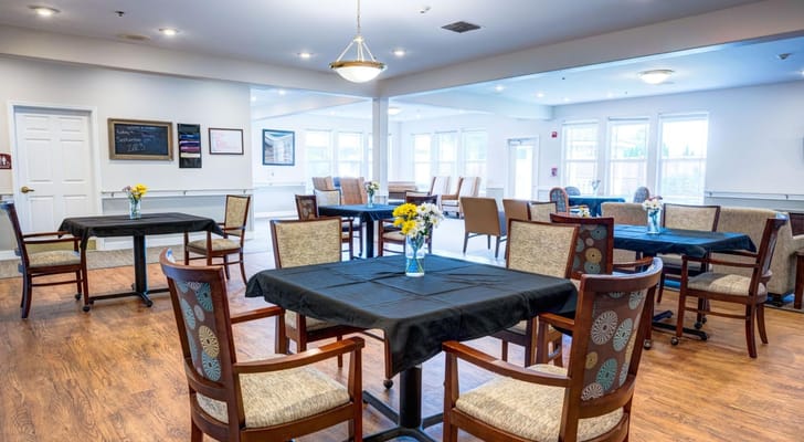 Bright dining room with tables and flowers