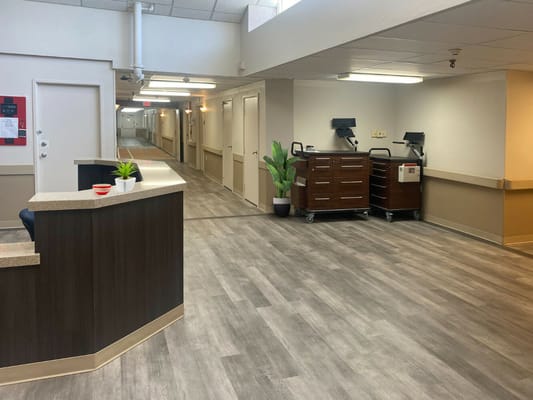 Modern reception area with a counter and hallway view.