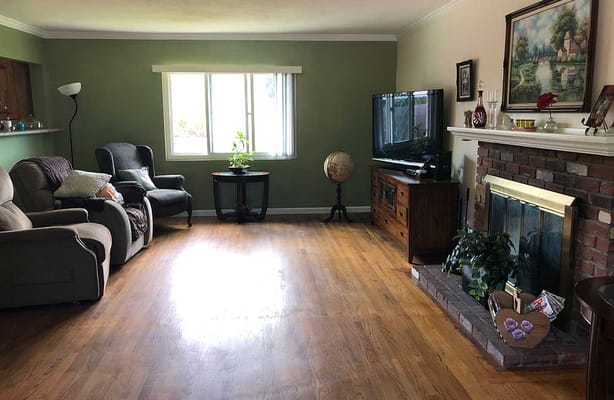 A spacious living room with comfortable seating and a television.