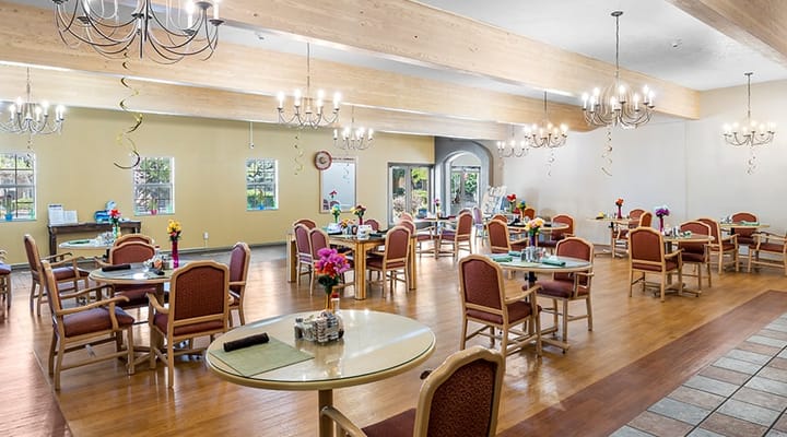 Dining area with tables and chairs, chandelier lighting