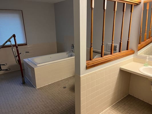 Spacious accessible bathroom with bathtub and sink