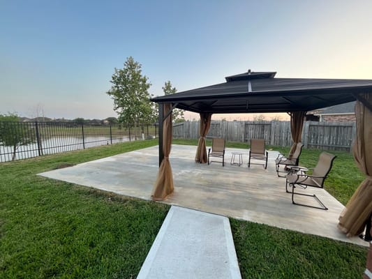 Outdoor seating area with a gazebo by the water