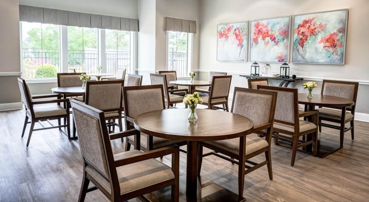 Bright and inviting common area with tables and flowers