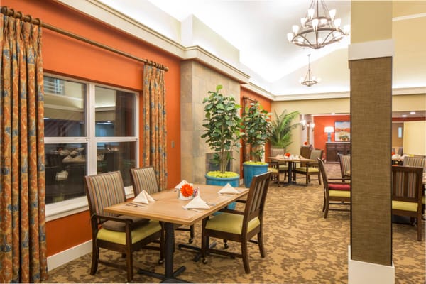 Bright and inviting dining room with tables set for guests