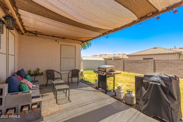 Outdoor patio with seating and grill