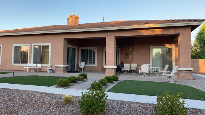 View of the patio area with seating and landscaping at Mary Grace Care Home.