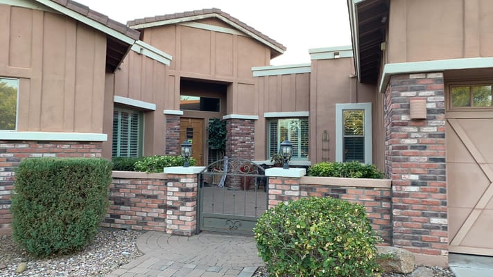 Front entryway of Mary Grace Care Home featuring brick accents and landscaping.