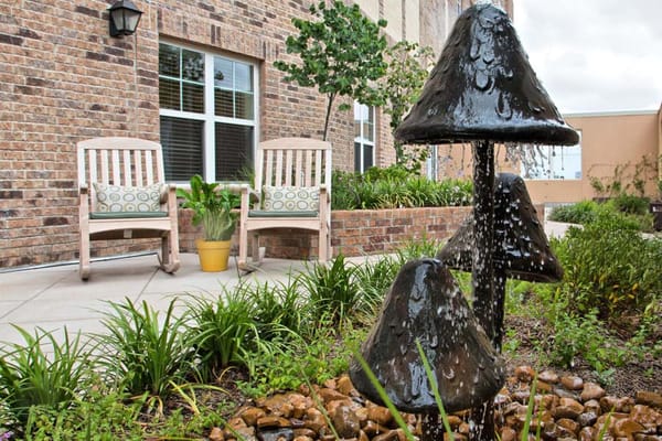 Outdoor seating area with water feature and plants