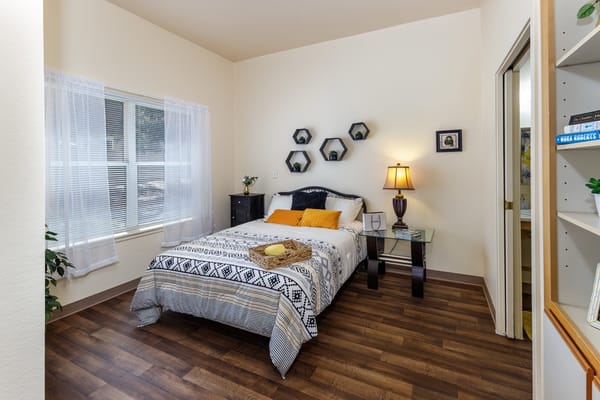 Cozy resident room with bedside table and lamp