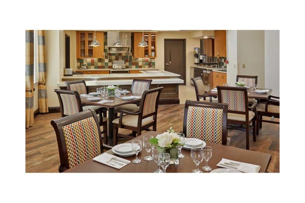 Dining room setup with plates and floral centerpieces