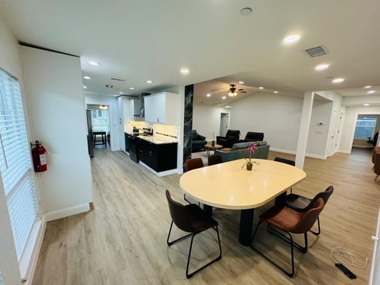 Bright common area with seating and dining space