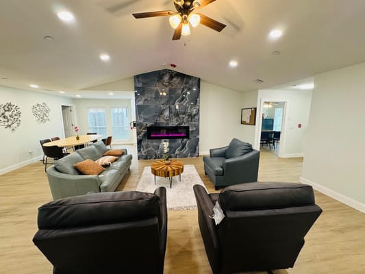 Bright common area with seating and fireplace