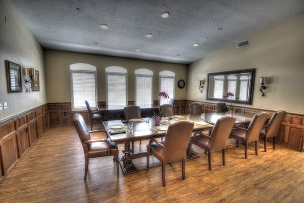 An elegantly set dining room with a large table and chairs