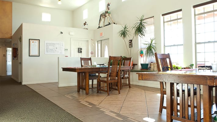 Bright common area with wooden tables and plants
