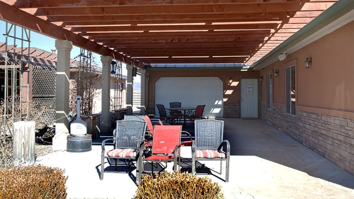 Outdoor patio area with seating and shade