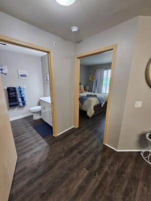 Entrance showcasing a bathroom on the left and a bedroom on the right