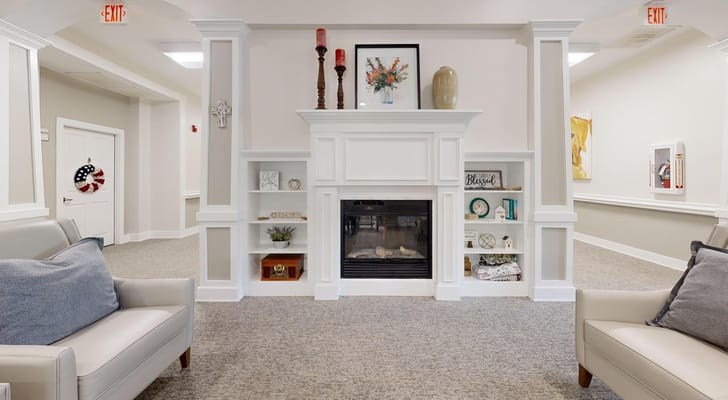Bright common area with comfortable seating and a fireplace