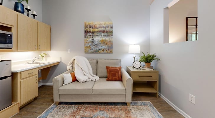 Cozy living room area with couch and artwork