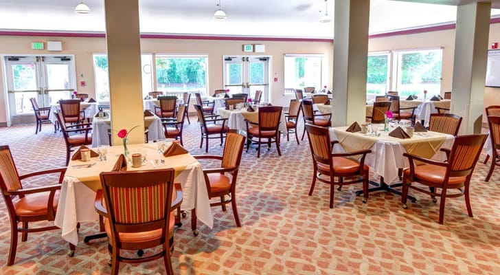 Bright dining room with tables set for residents