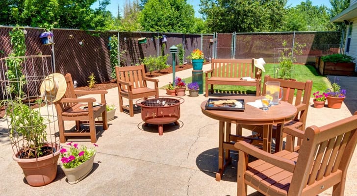 Inviting outdoor seating area with flowers and a fire pit