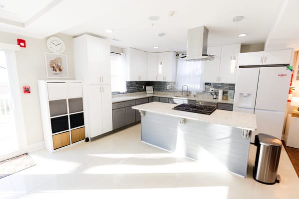 Bright modern kitchen area with white cabinets