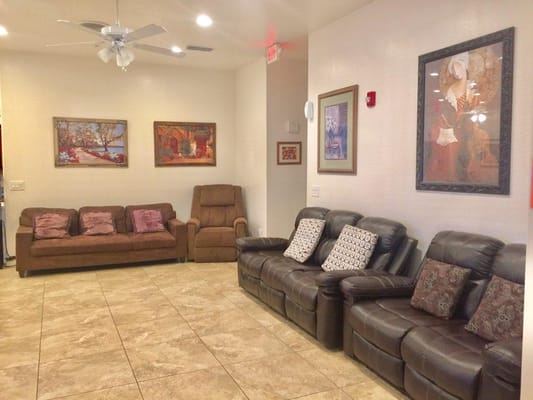 Lounge area with brown sofas and artworks on the walls