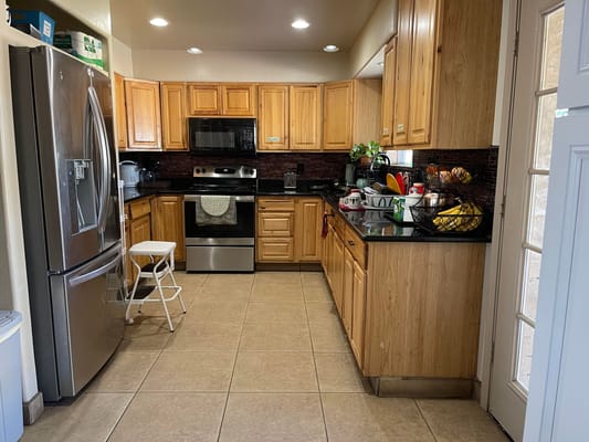 Well-equipped kitchen with wooden cabinets and appliances.