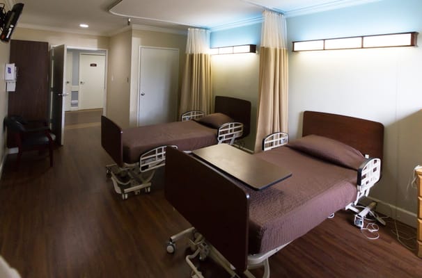 Interior of a shared resident room with beds and furnishings