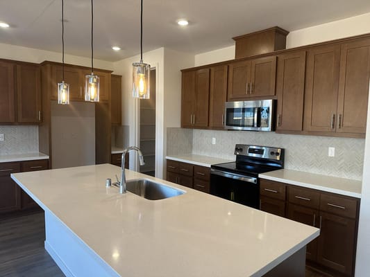 Light-filled kitchen with modern appliances and wood cabinetry