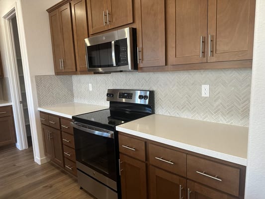 Modern kitchen with stainless steel appliances and wooden cabinets