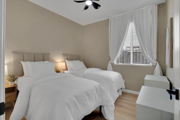 Cozy bedroom with two beds and natural light