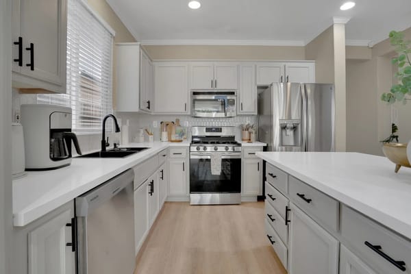 Spacious kitchen with modern appliances and white cabinetry