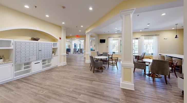 Bright common area with seating and mailboxes