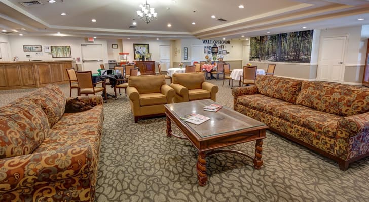 Living room area with patterned sofas and a wooden table