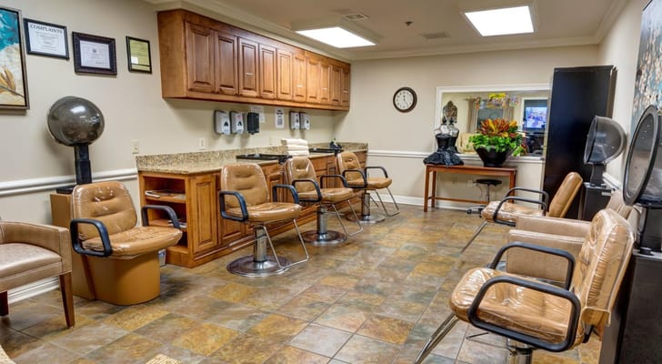 Interior view of the salon with chairs and styling stations