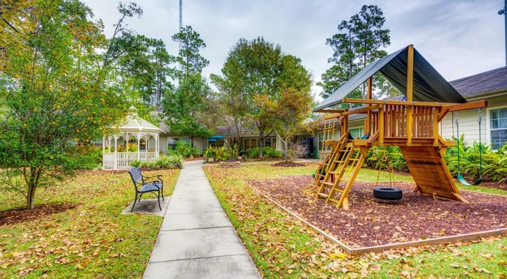 Playground equipment and gazebo in a landscaped garden