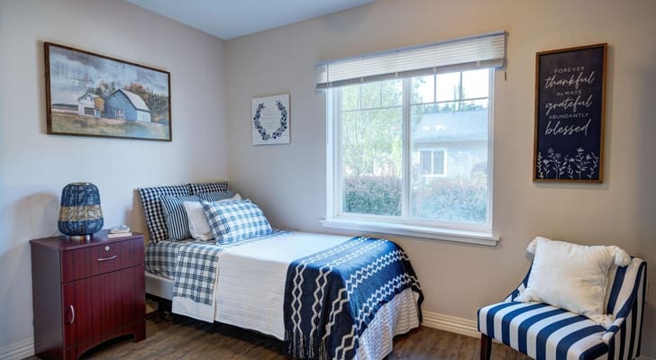 Cozy resident room with bed and artwork