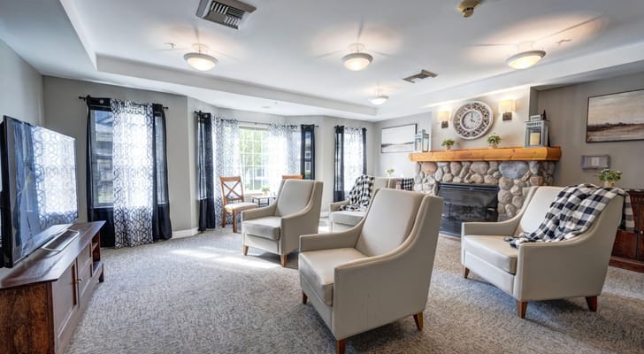Bright common area with seating and a fireplace