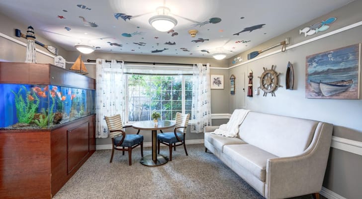 Bright common area with fish tank and seating.