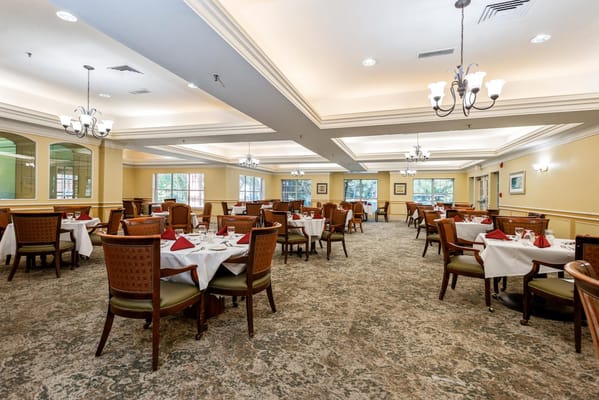 A spacious dining room with neatly set tables at The Forum at The Woodlands.