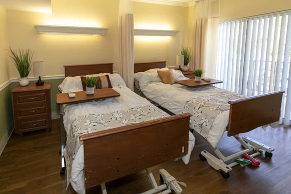 Two beds in a bright resident room with decor